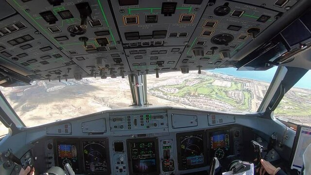 Pilots land the plane on the runway. View from inside the cockpit of a landing plane