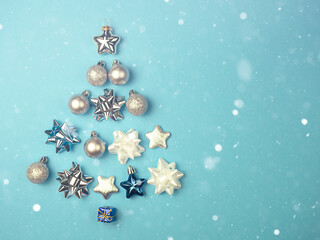 Christmas tree of balls, stars, and other elements on a blue background.