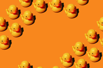 Seamless pattern: yellow rubber toy duck isolated on orange background; with copyspace