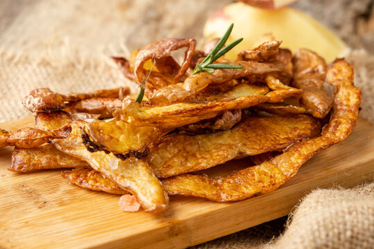 Crispy potato peel chips with rosemary and salt close-up. Sustainable food.