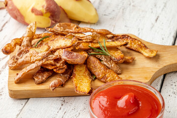 Homemade potato rind chips on a white wooden table.