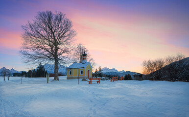 dreamy sunset scenery, Maria Rast chapel in winter. Buckelwiesen landscape bavaria