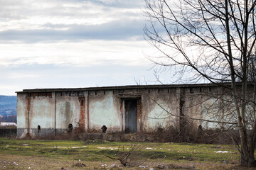Fototapeta na wymiar Abandoned warehouse. Degraded building.