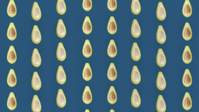 Colorful fruit pattern of fresh avocados on blue background. Seamless pattern with avocado. Realistic animation. 4K video motion