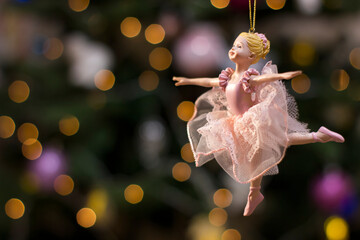 Ballerina toy figurine on Christmas tree. Holiday background.