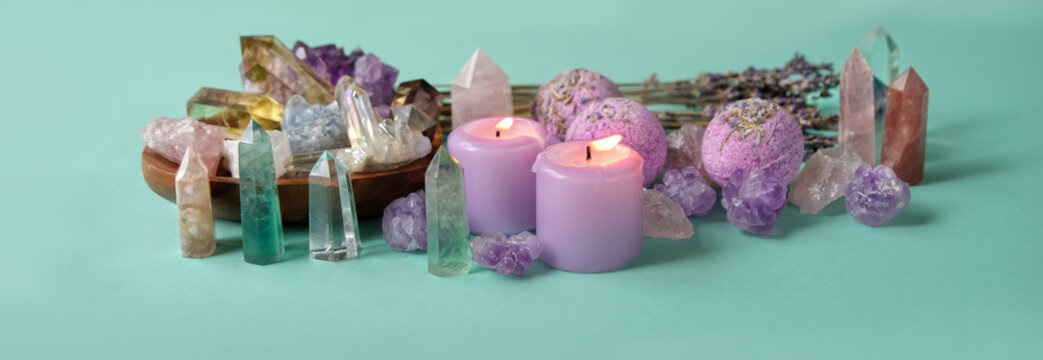 gemstones minerals, candles, lavender flowers, bath bombs on green background. Crystal ritual, Esoteric spiritual practice, spa, relax time. Wiccan Witchcraft. banner