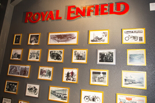 Royal Enfield motorcycle logo brand and text sign in dealership store interior old wooden framed poster wall motorbike