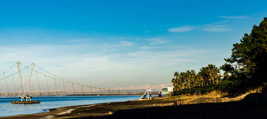 Black volcanic sand beach and Caucasus mountains