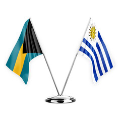 Two table flags isolated on white background 3d illustration, bahamas and uruguay