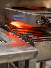 Closeup view of automatic heater stove heating PVC machine in factory