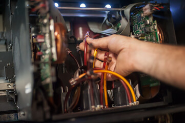 Closeup view of electrical engineer operator repairs industrial printer plotter