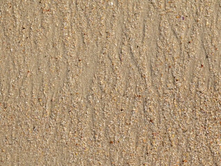 Fototapeta premium Lines in the sand of natural waves forming lozenge patterns when ocean waves return to the ocean. Conceptual image about the patterns we create in life.