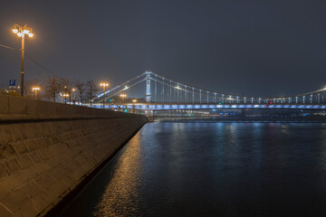 Crimean bridge in the fog at night. Night city. Steel suspension bridge in Moscow.
