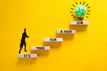 It is time for a new job symbol. Wooden blocks with words It is time for a new job. Beautiful yellow background, copy space. Businessman icon, light bulb. Business, time for a new job concept.