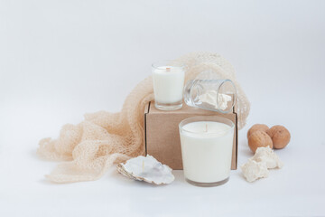 Set of Two Soy Wax Candles on the white table. White vase with dried flower. 