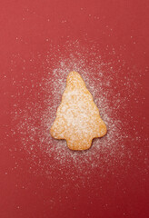 home made cookie in shape of tree. isolated on red background