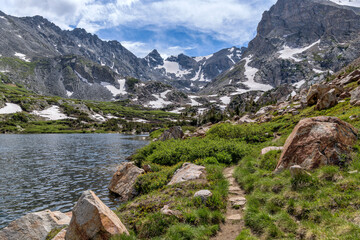 Pawnee Pass Trail - A Spring day view of Pawnee Pass Trail winding at west end of Lake Isabelle towards rugged Indian Peaks.  Indian Peaks Wilderness, Colorado, USA.