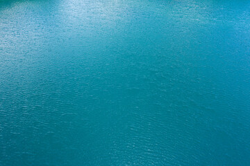 Blue water in the pond texture drone view.