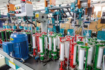 Machinery and equipment in a yarn manufacturing company. Textile industry. Spinning machine in a...