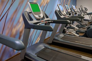 Close-up of run machines, treadmill in fitness room at gym or wellness spa resort. Fitness, sport, cardio workout, healthy and active lifestyle concept