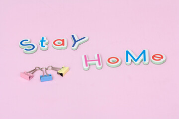 STAY HOME - text on stay home concept  on pink background.