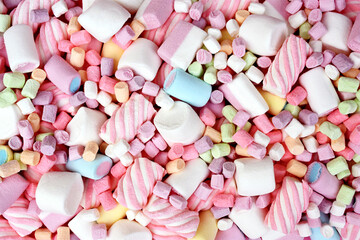 Confectionery and sweeties background: light pink and white marshmallows, sugar confetti, bonbon and candies