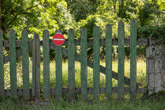 Green fence with no-go sign