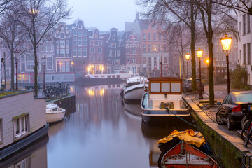 Evening Amsterdam canal Groenburgwal in the morning mist, Holland, Netherlands.