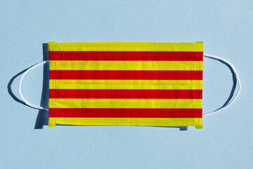 Catalonia flag on medical face mask. Restrictions in Spain