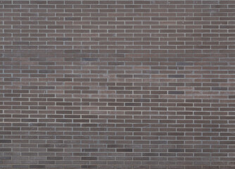 Dark brown bricks dirty wall background with little paint stains