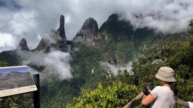 Tourist hike Postcard trail viewpoint showing Brazil panoramic landscape of mountain range Serra dos Orgaos with Dedo de Deus, Gods finger peak
