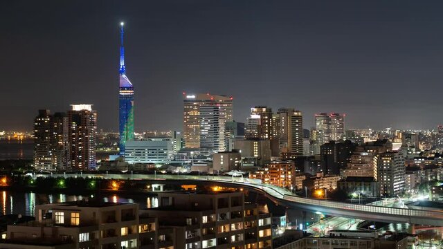 福岡市博多区の夜のスカイラインと高速道路と飛行機のタイムラプス映像（右から左へのパンニング）