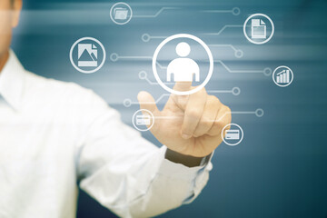 Close up of businessman hand pointing at business icons.Human Resources concept.