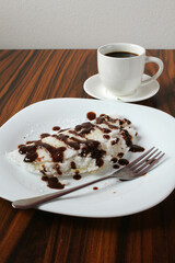Brazilian dessert. Sweet tapioca, tapioca stuffed with coconut grated and chocolate syrup topping with coffee cup.