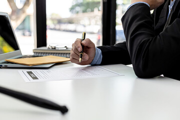 Lawyer reads the contract between the client and the parties, he has drawn up a contract to defend...