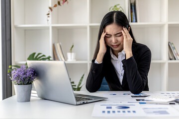Beautiful Asian woman working in an office, she is a businesswoman who owns a company, she has a...