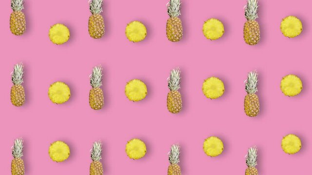 Colorful fruit pattern of fresh pineapple on pink background. Seamless pattern with pineapple sliced. Realistic animation. 4K video motion