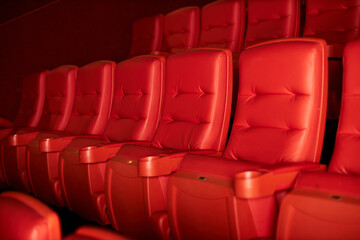 Empty rows of red theater or movie seats. High quality photo