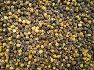 Black chickpeas, also known as bengal grams, garbanzo beans or kala chana in local language. Dried or roasted chickpeas background.