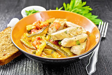 Chicken with stewed zucchini in plate on board