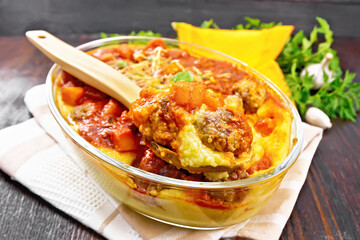 Porridge corn with meat and spoon in roaster on towel