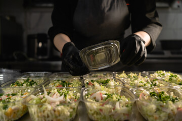 Healthy food delivery. organic healthy salad in a disposable bowl. Clean food concept, healthy...