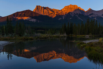 Sunrise view of Policeman's Creek along the Bow River outside Canmore, Alberta. Mount Lawrence Grassi with Ha Ling Peak on the far right of Mount Grassi.
