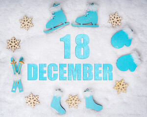 December 18th. Sports set with blue wooden skates, skis, sledges and snowflakes and a calendar date. Day 18 of month.