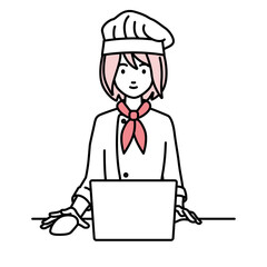 デスクで座ってPCを使っている調理師の女性