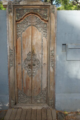 closeup of an old wooden intricate door in a wall on the tropical island of la réunion france