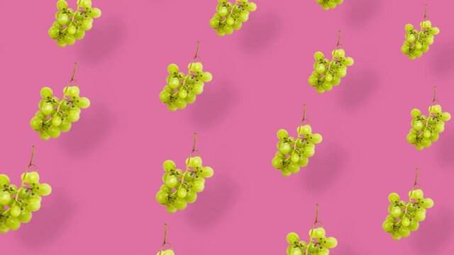 Colorful fruit pattern of fresh grapes on pink background with shadows. Seamless pattern with grape. Realistic animation. 4K video motion