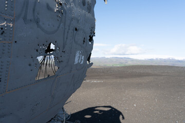 Impressive view of the Sólheimasandur Plane Wreck, the Remains of a 1973 U.S. Navy DC plane that crashed on black sand beach in Iceland