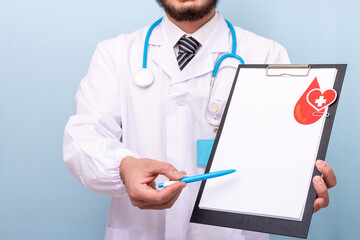 Doctor hands holding blood donation form.