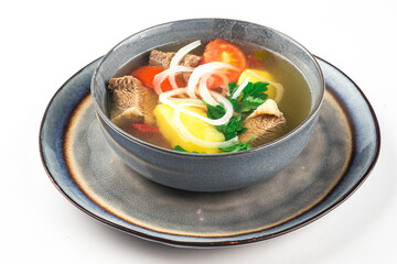 Isolated uzbek national shurpa lamb soup on white background